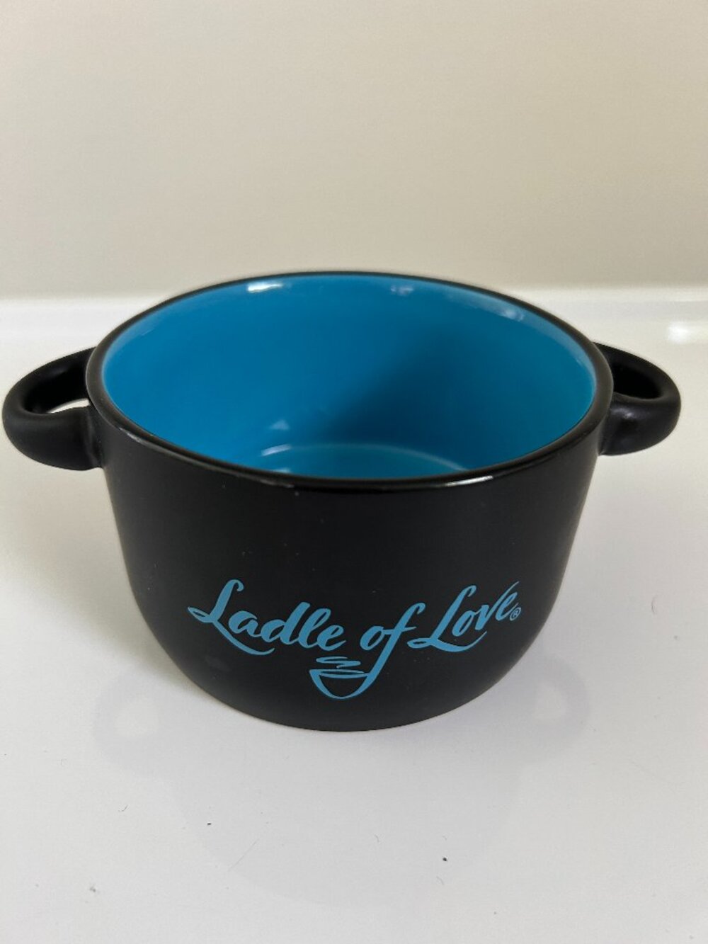 SMALL BLACK BOWL WITH HANDLES TURQUOIS GLAZED INTERIOR